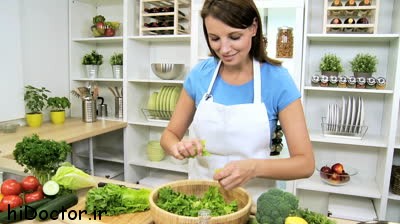 stock-footage-young-woman-in-the-kitchen-preparing-a-fresh-green-salad-as-part-of-a-modern-healthy-diet