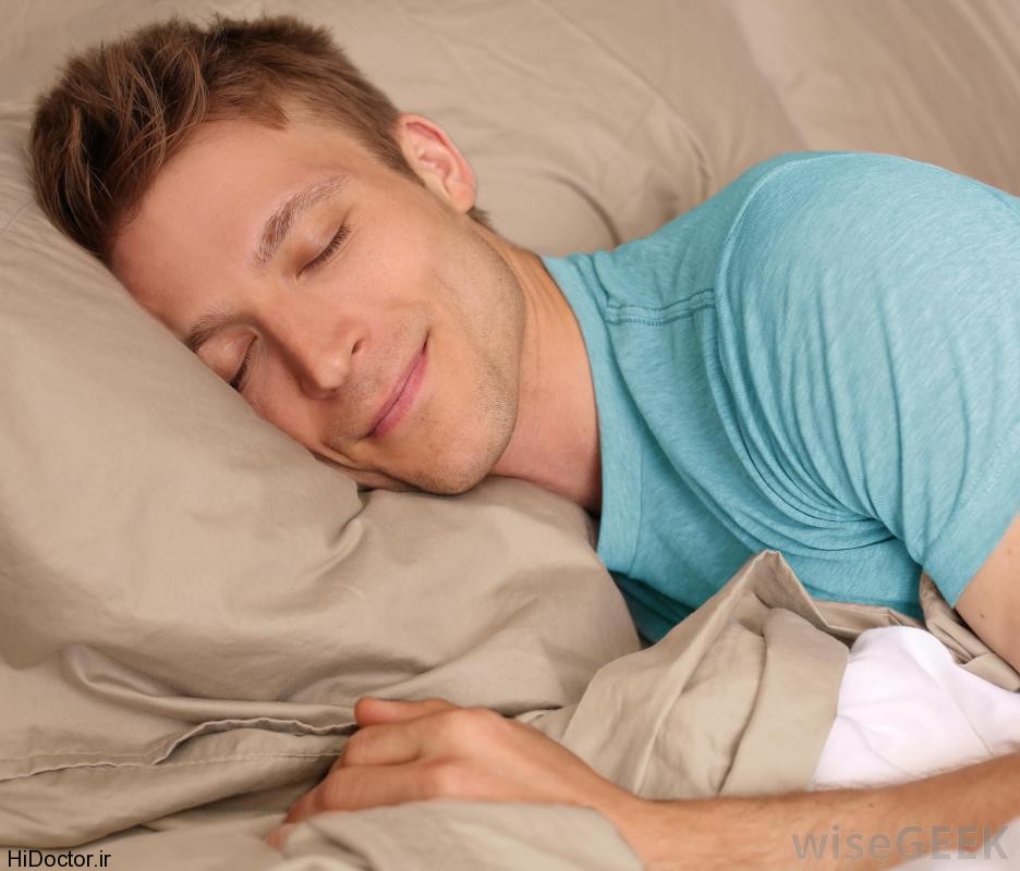 man-in-blue-sleeping-on-beige-pillow