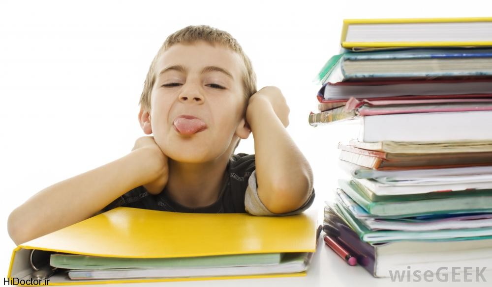 boy-sticking-out-tounge-with-stacks-of-books