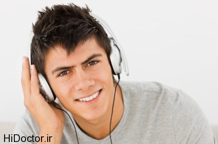 Closeup portrait of a young man listening to music isolated on white background