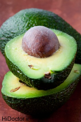 Close-up of avocado halves on a wooden background