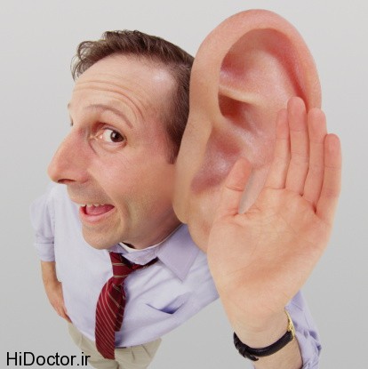 Man cupping hand over big ear (Digital Composite)