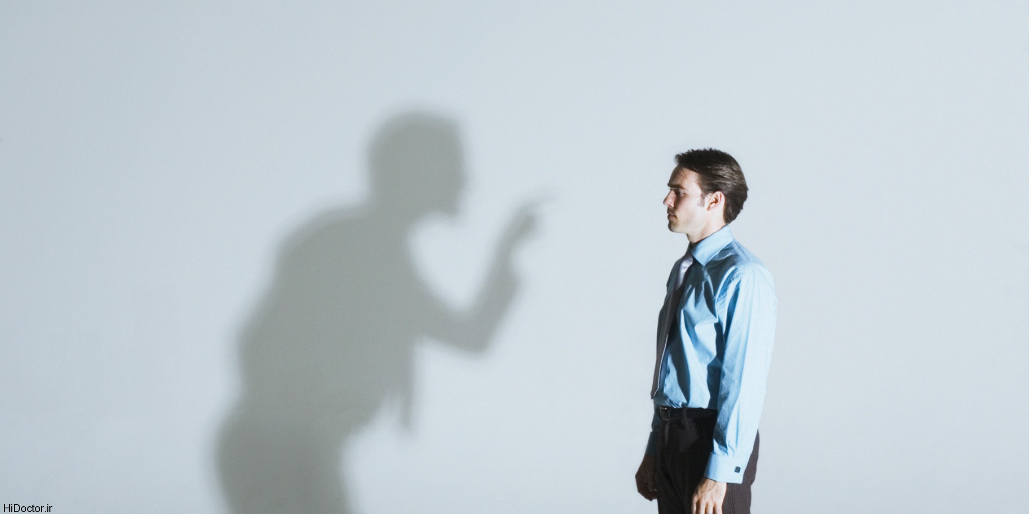 Man being scolded by his shadow