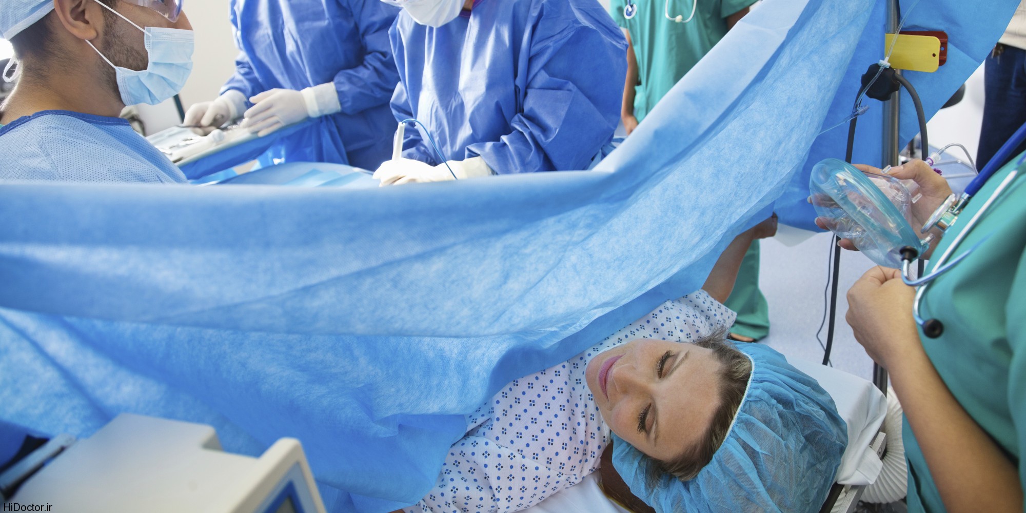 Surgical team performing Caesarean section on pregnant woman