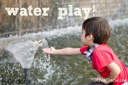 Little boy touching water the fountain