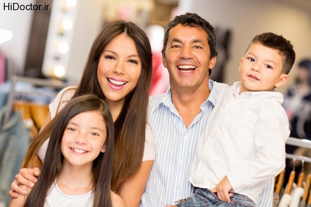 Portrait of happy family in a clothing store smiling