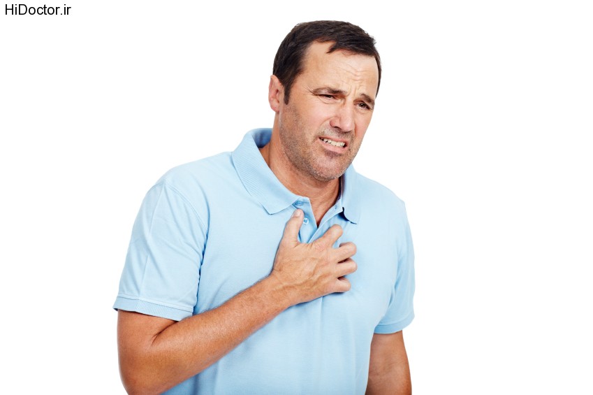 Mature man showing the early symptoms of a heart attack while isolated on white