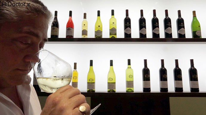 A wine merchant examines wine as he visits Vinexpo, the world