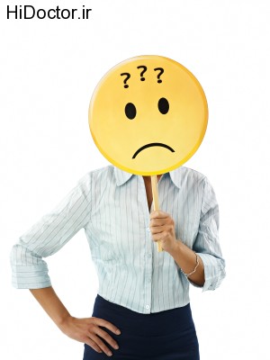 adult business woman holding emoticon with question marks on white background. Vertical shape, waist up