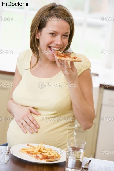 depositphotos_4780571-Pregnant-woman-in-kitchen-eating-French-fries-and-pizza-smiling