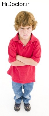 Young boy with arms crossed angry