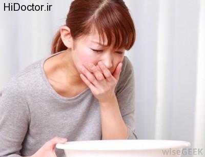 woman-with-red-hair-and-gray-shirt-with-hand-to-her-mouth-and-vomit-bowl