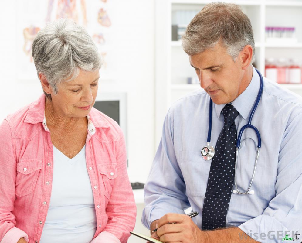 older-woman-in-pink-near-male-doctor