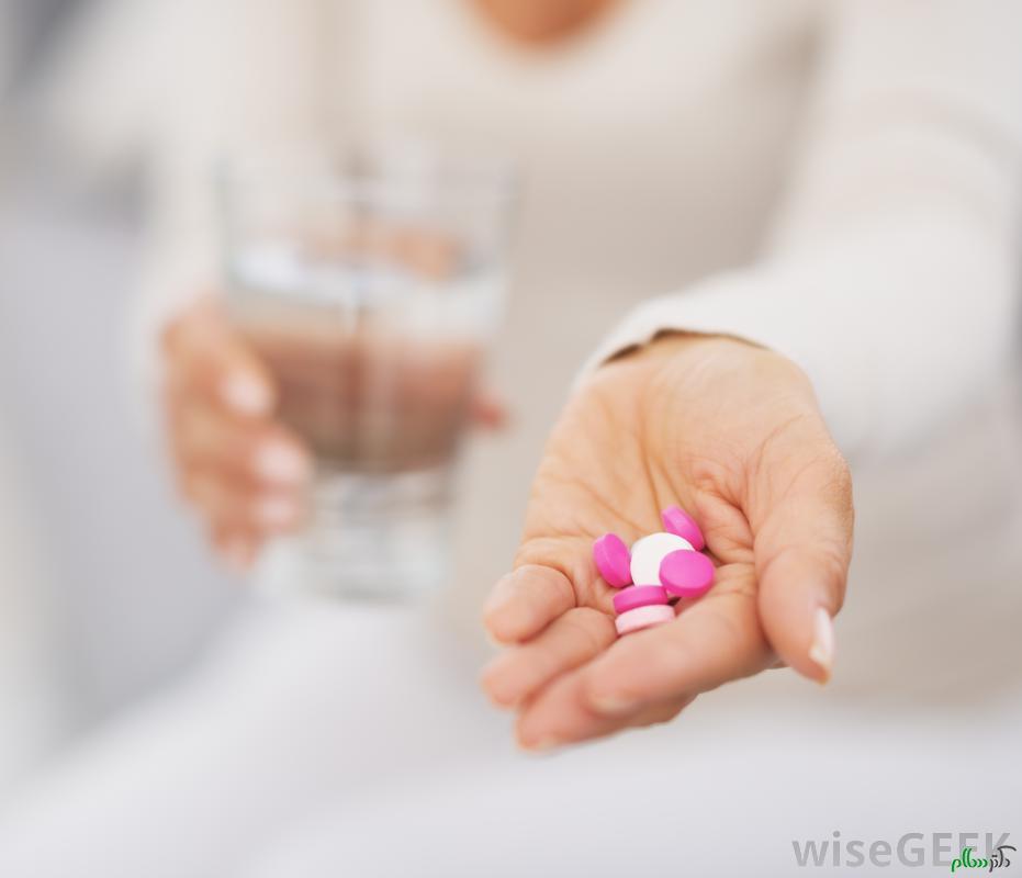 woman-holding-pink-and-white-pills
