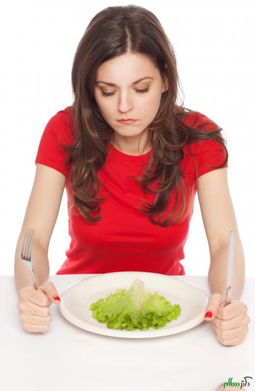 woman-in-red-looking-at-tiny-salad-on-plate