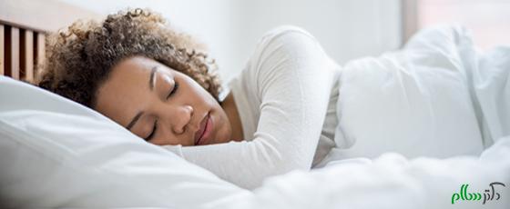 Tired black woman sleeping and looking very comfortable in her bed