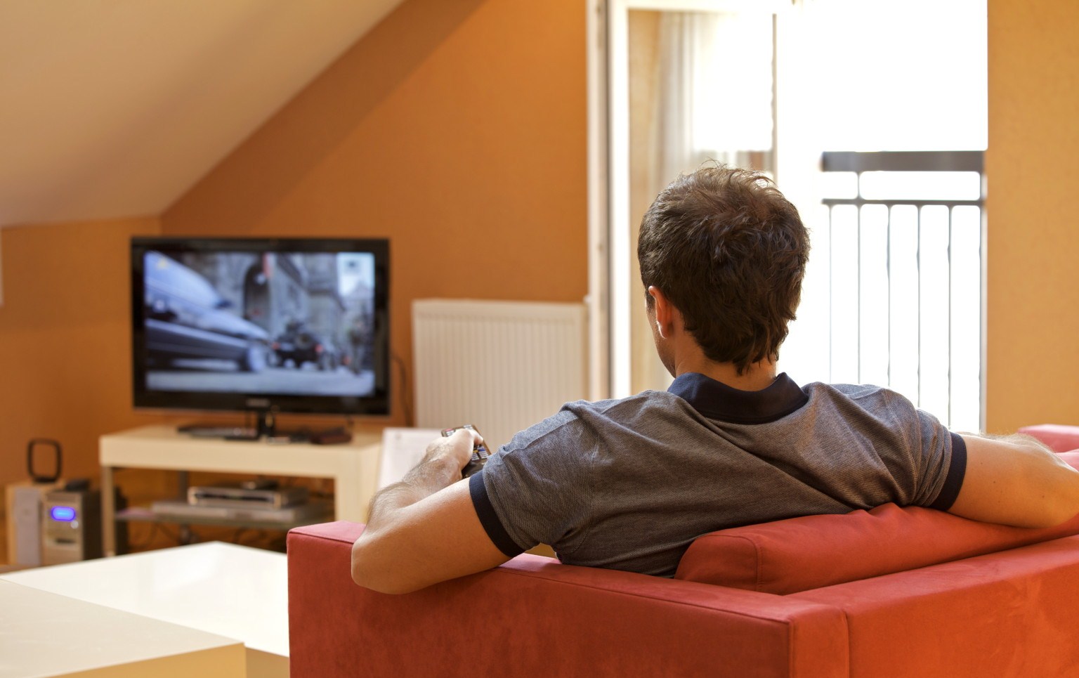 Rear view of young man watching television; Shutterstock ID 67308952; PO: The Huffington Post; Job: The Huffington Post; Client: The Huffington Post; Other: The Huffington Post