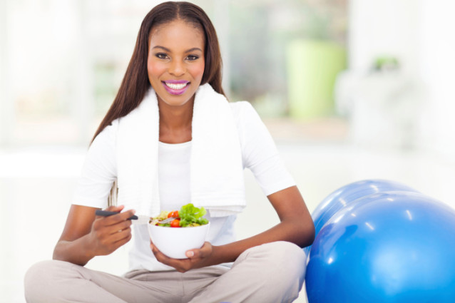 african woman eating healthy salad